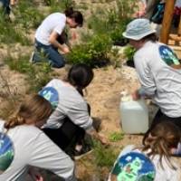 Beaver Island Participants planting and watering